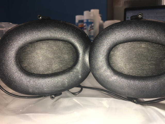 An image of DD450 headphones with discoloration of the transducer mesh.