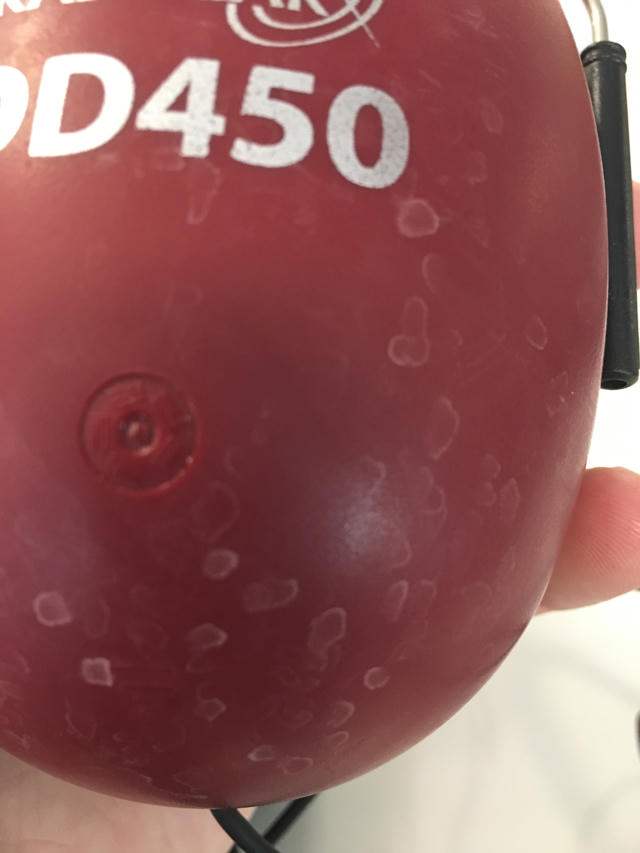 An image of DD450 headphones with discoloration on the outside of the earcup.